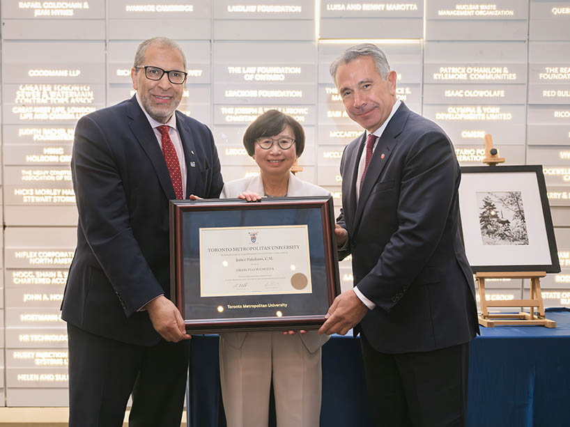 Janice Fukakusa with President Mohamed Lachemi and Tony Staffieri as they are handing her an award plaque.