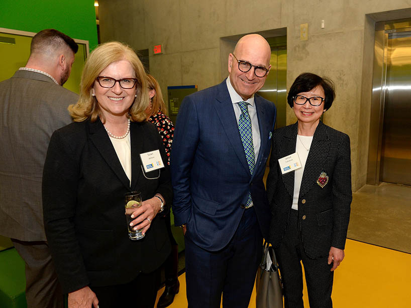 Chancellor Fukakusa stands beside two attendees at the Harry Rosen ceremony.